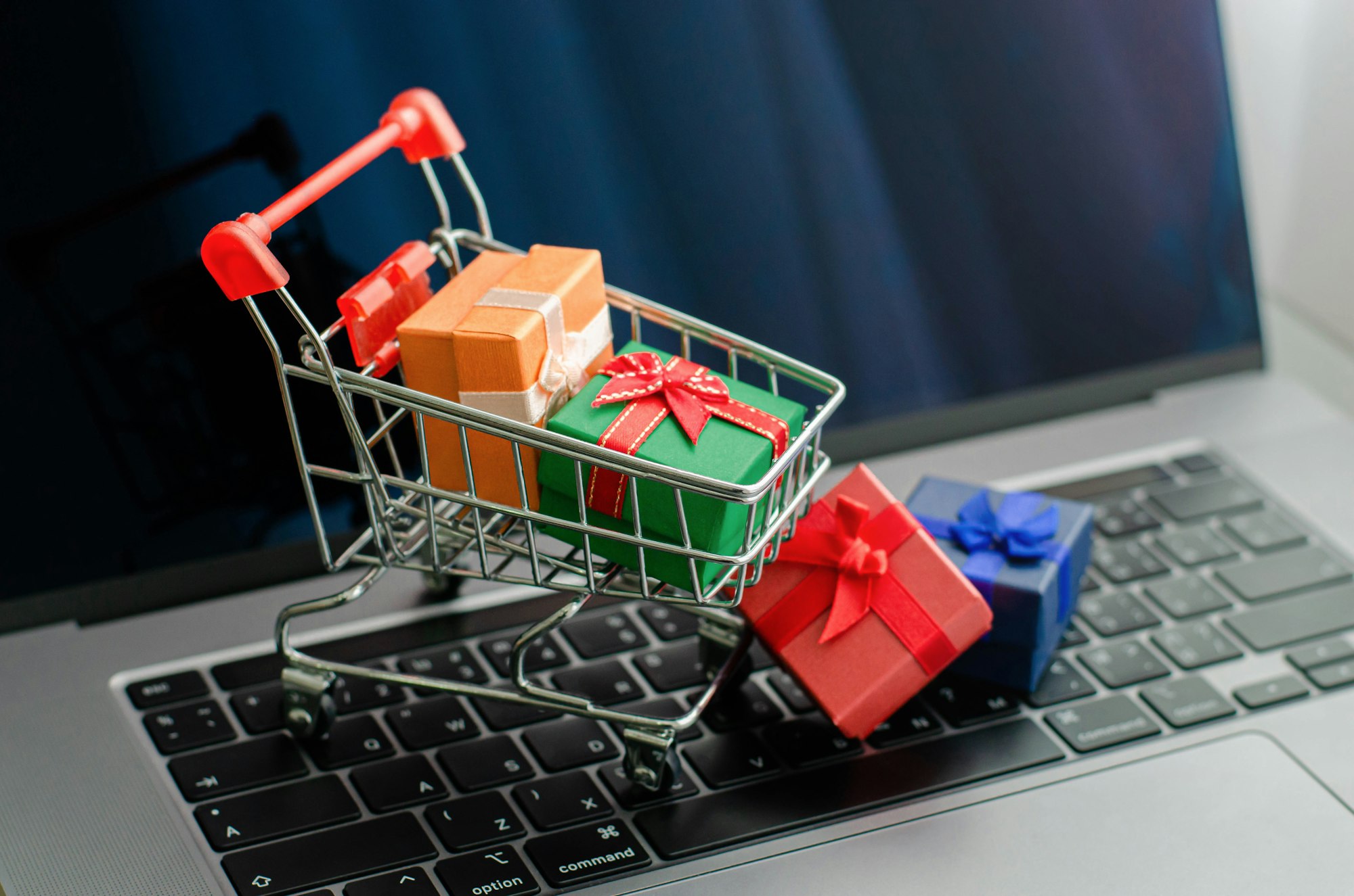 Black friday mini shopping bags in cart on the keyboard Online shopping ideas